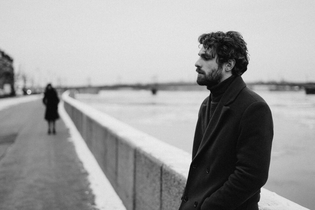 black and white photography on man in black coat