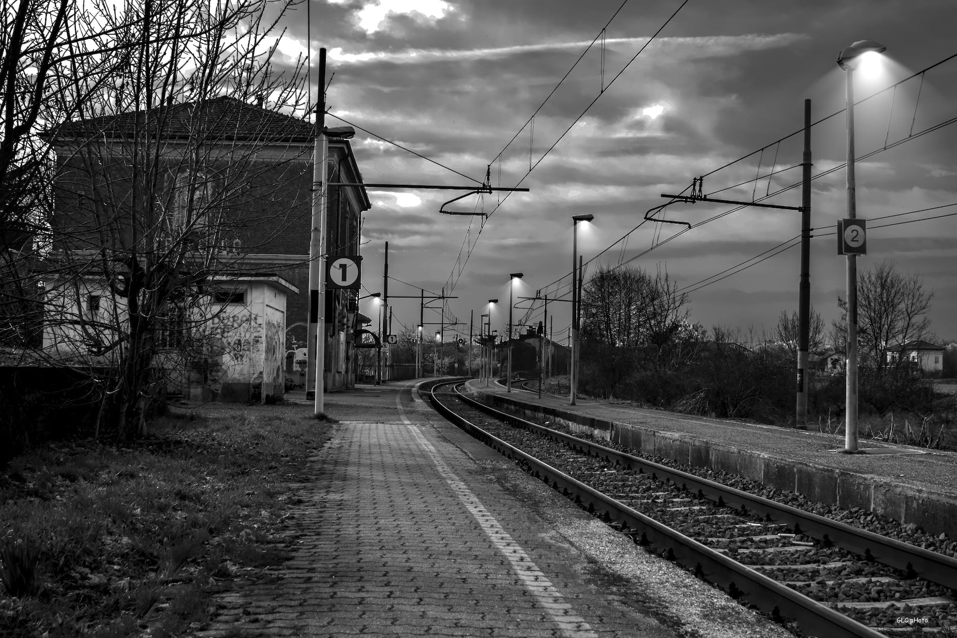 railroad tracks by bare trees against sky | Poem: To The Next Station