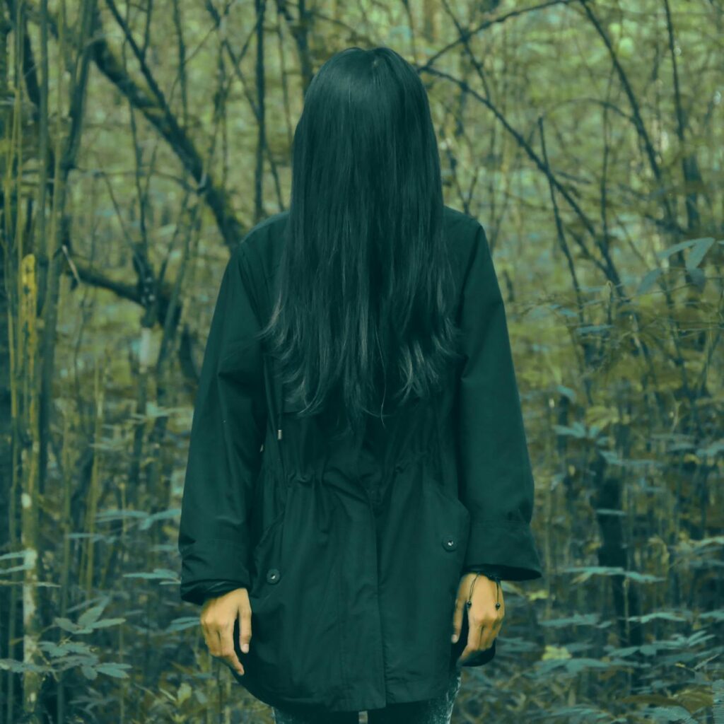 person in black coat standing in forest: The only GHOST I met was LIE and the only GOD I believe in is TRUTH.