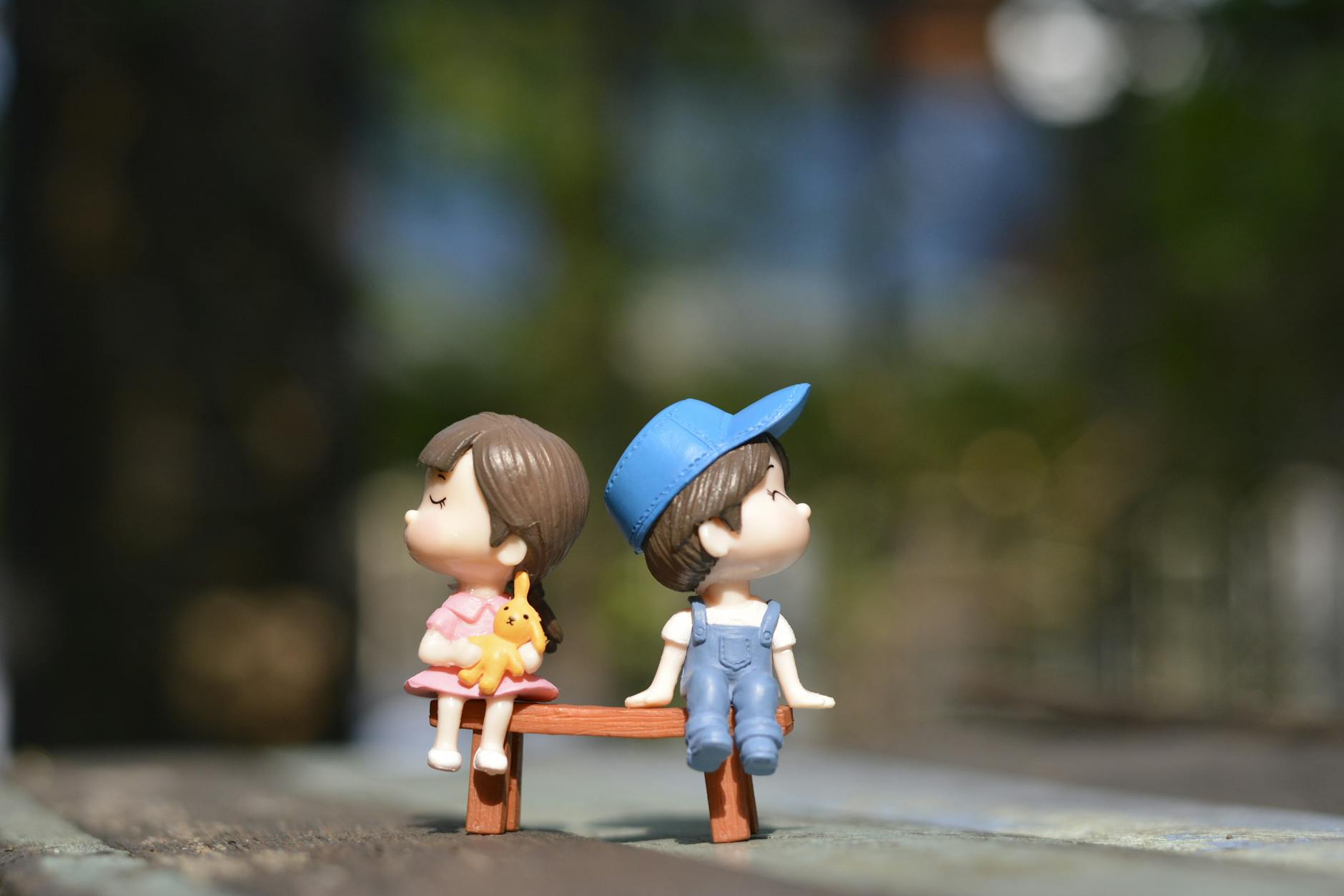 boy and girl sitting on bench toy: Explore why saying “I love you” feels so hard—and how vulnerability, fear, and love languages shape the way we express love. Let it out, imperfect but real.