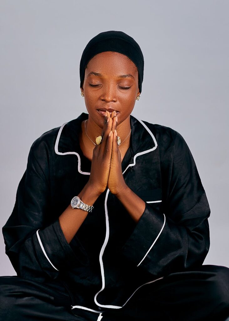 serene woman meditating in black attire