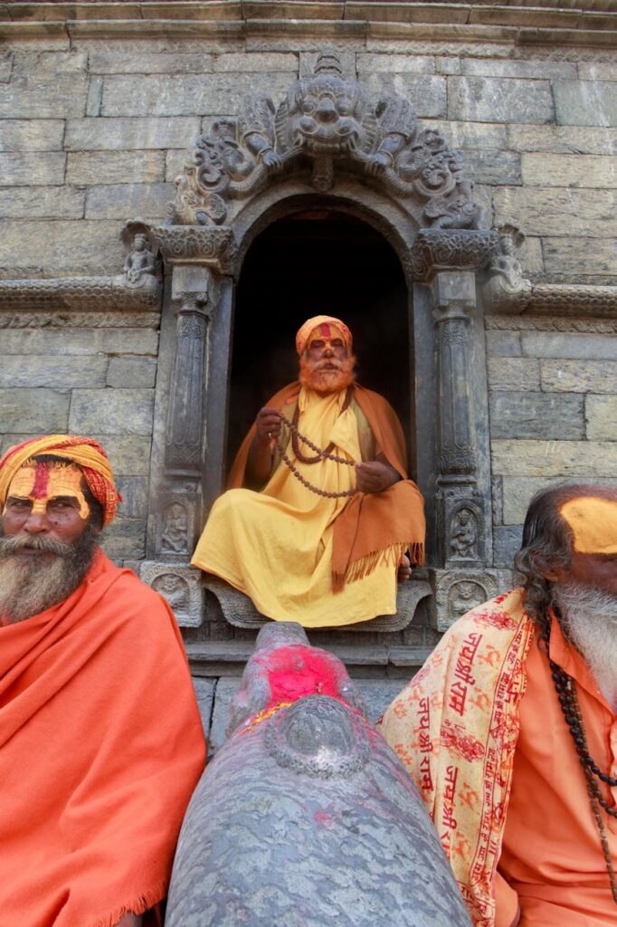 men in traditional clothing and face paint during ceremony: Learn what I discovered about the power of chanting or deep breathing 108 times. Uncover the significance of this ancient practice, how it can awaken your Ajna chakra, and shift your vibration for profound clarity and focus.
