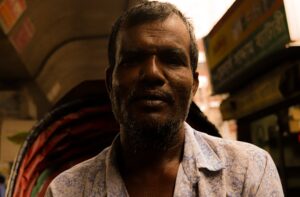 portrait of a man in a shirt on a street market