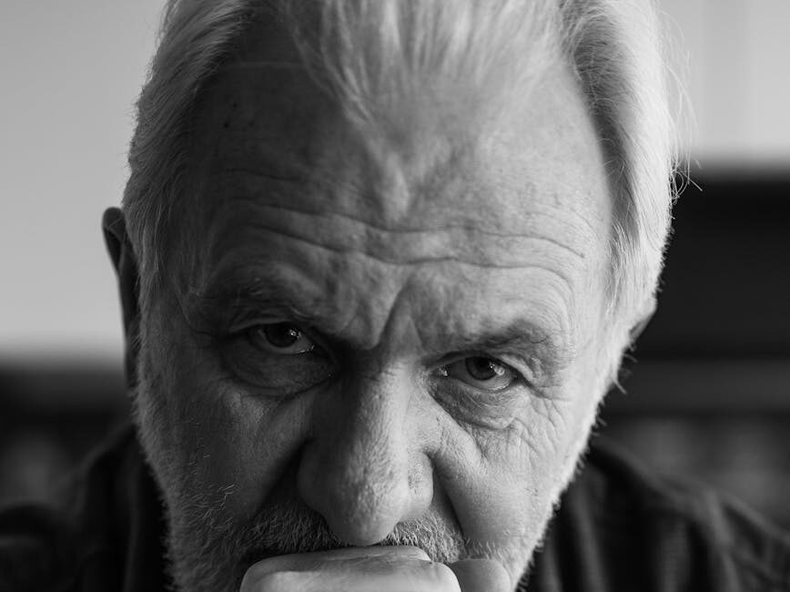 elderly man with hand on face: Explore how truth, clarity, and perseverance counter false narratives and fuel sustainable growth, innovation, and personal excellence.