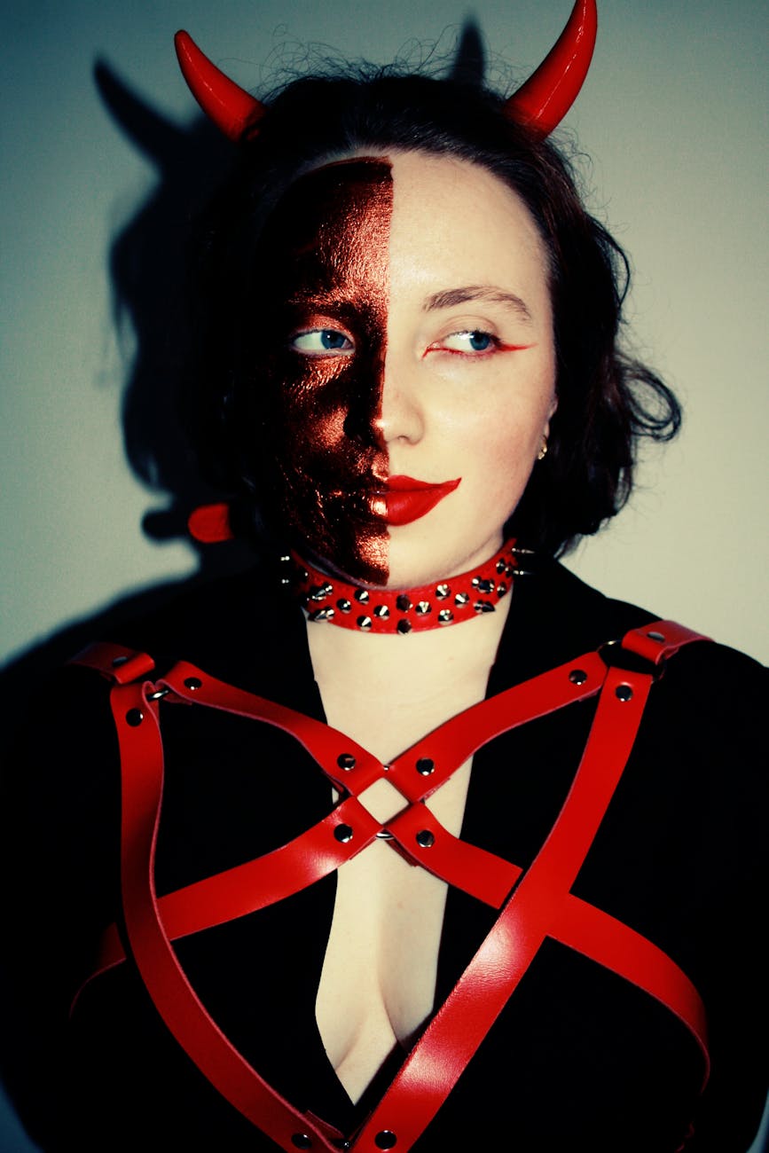 portrait of woman wearing devil costume: A haunting poetic reflection on oppression, silence, and complicity across gender, caste, class, religion, and nation. “I Saw the Devil” asks: what if the devil we fear is not a monster — but ourselves?