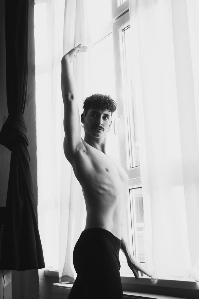 black and white male ballet studio portrait: In a world obsessed with unrealistic beauty standards, this heartfelt reflection explores the harmful impact of body shaming—from weight and skin color to hair and height—and urges us to embrace our flaws, celebrate diversity, and reclaim our self-worth.