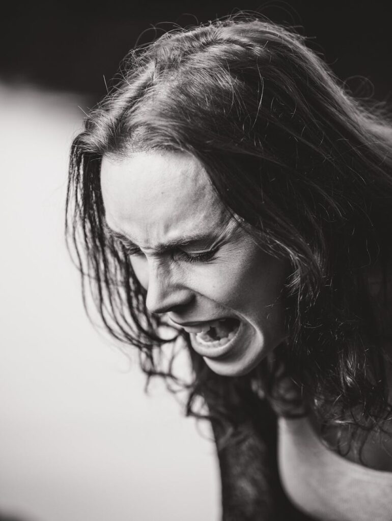dramatic black and white emotional expression portrait: This essay explores effective anger management techniques and the rising impact of digital disorders. It discusses causes, symptoms, and evidence-based strategies for emotional regulation, along with practical solutions for overcoming smartphone and internet addiction to promote mental well-being.
